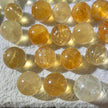Polished citrine spheres for healing, chakra balance, and spiritual growth, displayed on soft white fabric.