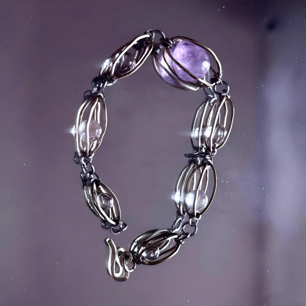 Handmade amethyst and clear crystal bracelet with wire-wrapped links for spiritual healing and chakra balance