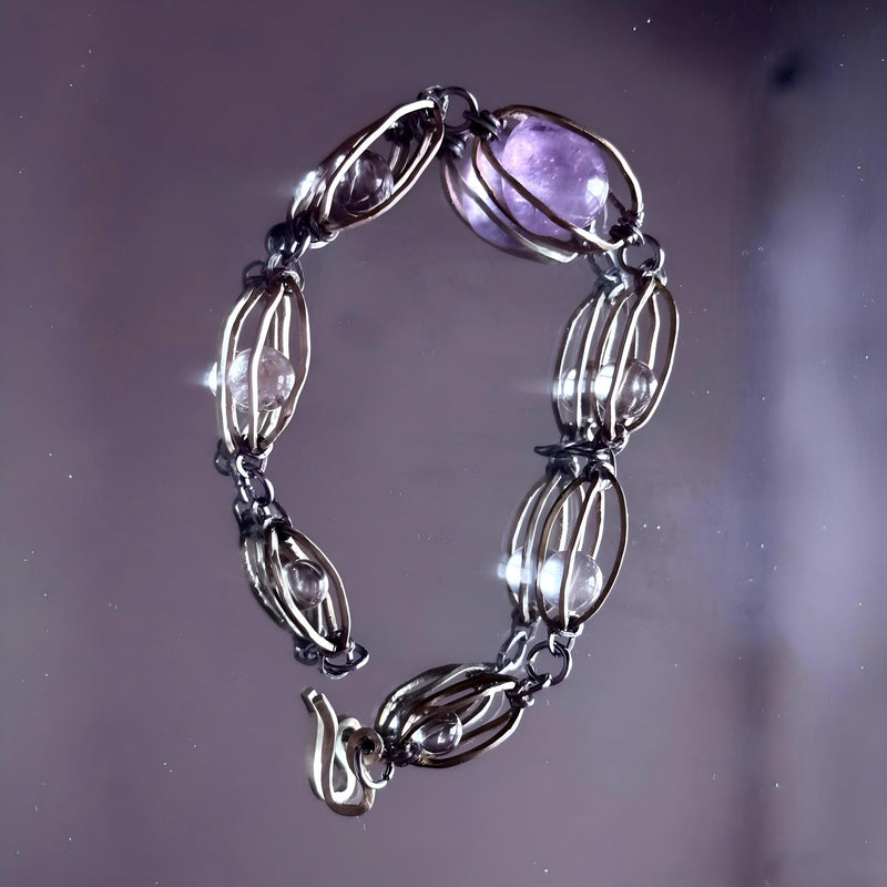 Handmade amethyst and clear crystal bracelet with wire-wrapped links for spiritual healing and chakra balance
