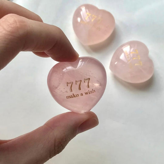 Pink heart-shaped rose quartz crystal with 777 make a wish engraving, spiritual healing stone