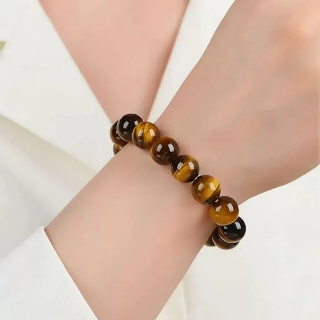 Tiger eye gemstone bracelet for protection and spiritual growth, worn on wrist