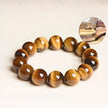 Tiger's Eye bracelet with natural stone beads for protection and spiritual growth, shown with raw crystal inset.