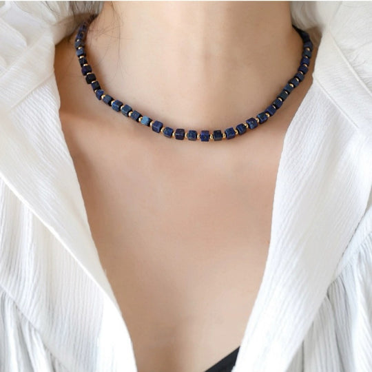 Lapis lazuli cube bead necklace for spiritual healing and chakra balance, worn with white blouse
