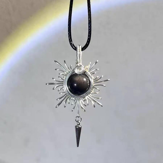 Handmade sunburst pendant with black crystal and silver wire, spiritual jewelry for protection and healing