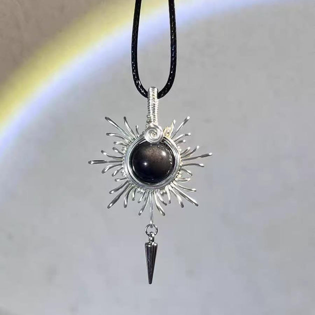 Handmade sunburst pendant with black crystal and silver wire, spiritual jewelry for protection and healing