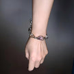Hand wearing rose quartz and pearl gemstone bracelet for love and healing energy