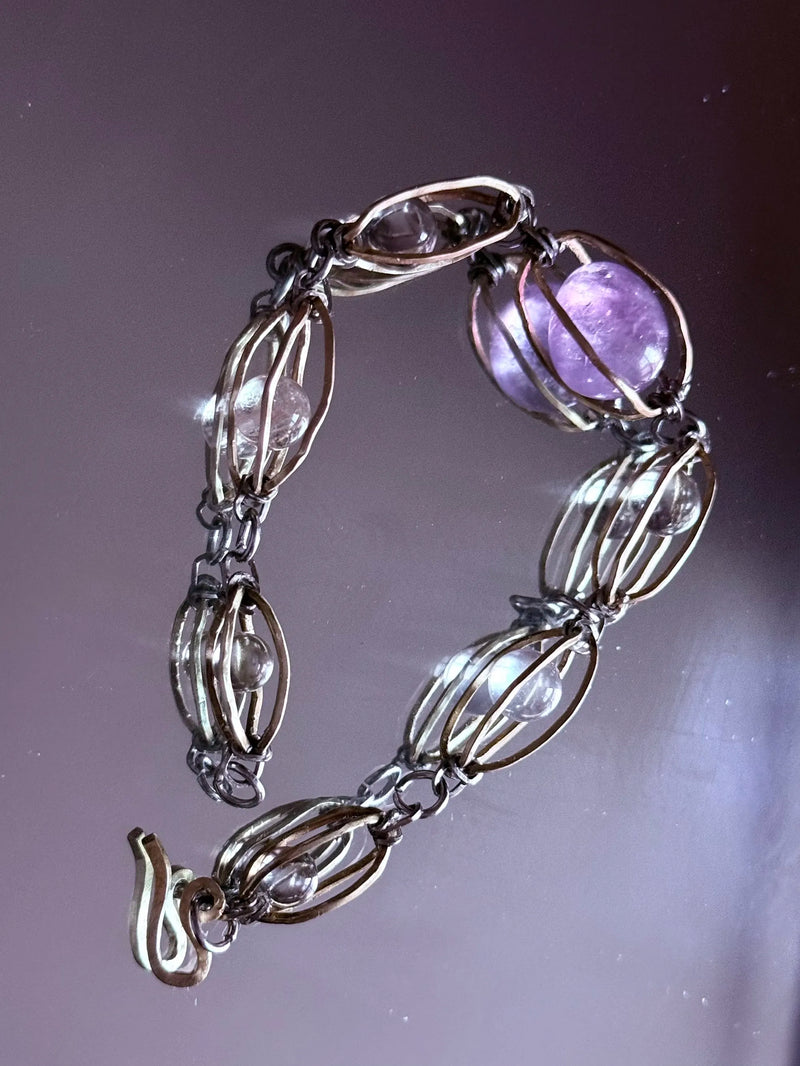 Handmade amethyst and clear crystal bracelet with wire-wrapped links for spiritual healing and chakra balance