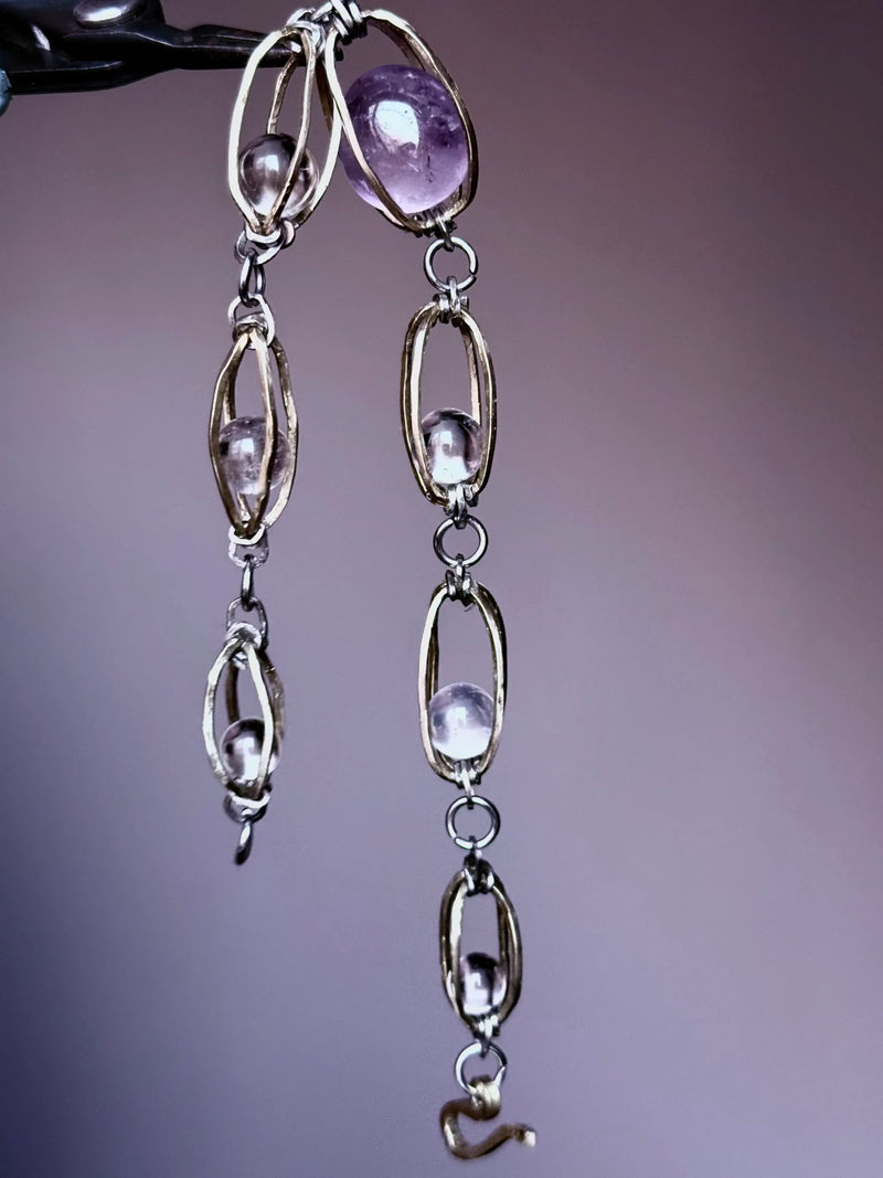Handmade amethyst and clear crystal gemstone necklace with silver-toned chain links for spiritual healing and protection.