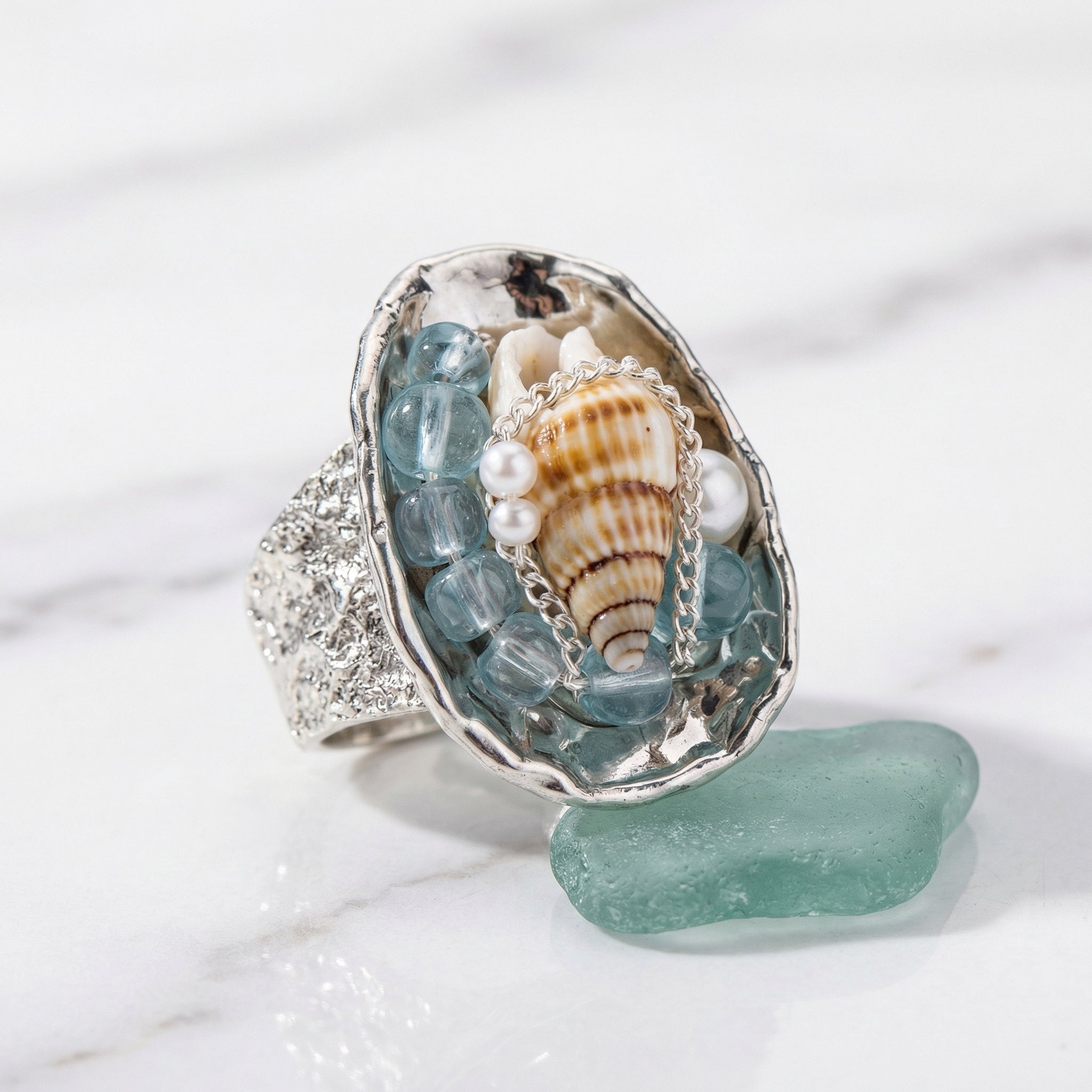 Handmade silver ring with seashell, aquamarine beads, pearls, and sea glass for spiritual healing and coastal charm