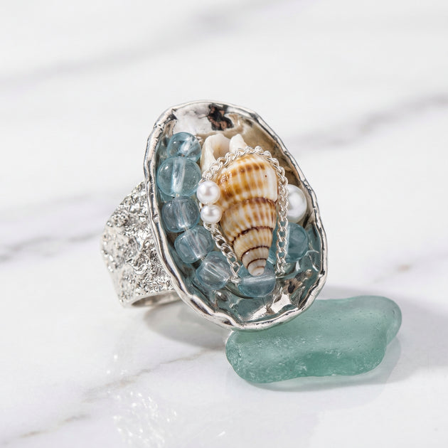 Handmade silver ring with seashell, aquamarine beads, pearls, and sea glass for spiritual healing and coastal charm