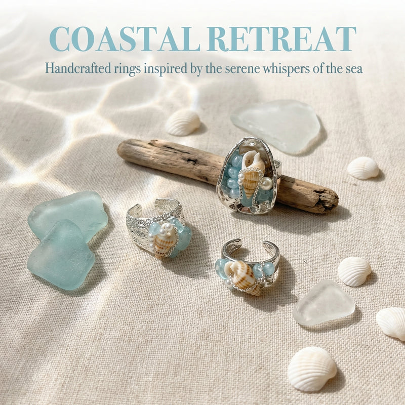 Handcrafted sea-inspired rings with seashells, pearls, and blue stones on driftwood and sea glass