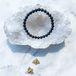Black onyx beaded bracelet on crystal geode, gold bee charms, healing crystals for protection and grounding