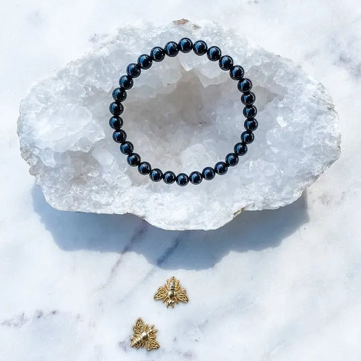 Black onyx beaded bracelet on crystal geode, gold bee charms, healing crystals for protection and grounding