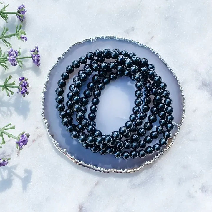 Black onyx beaded necklace on agate slice with lavender, for protection and spiritual healing