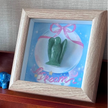 Green jade angel figurine in wooden frame with 'Dream' artwork, chakra healing crystal decor