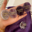 Hand holding engraved amethyst and agate affirmation stones with 'I want it I got it' for manifestation and spiritual growth