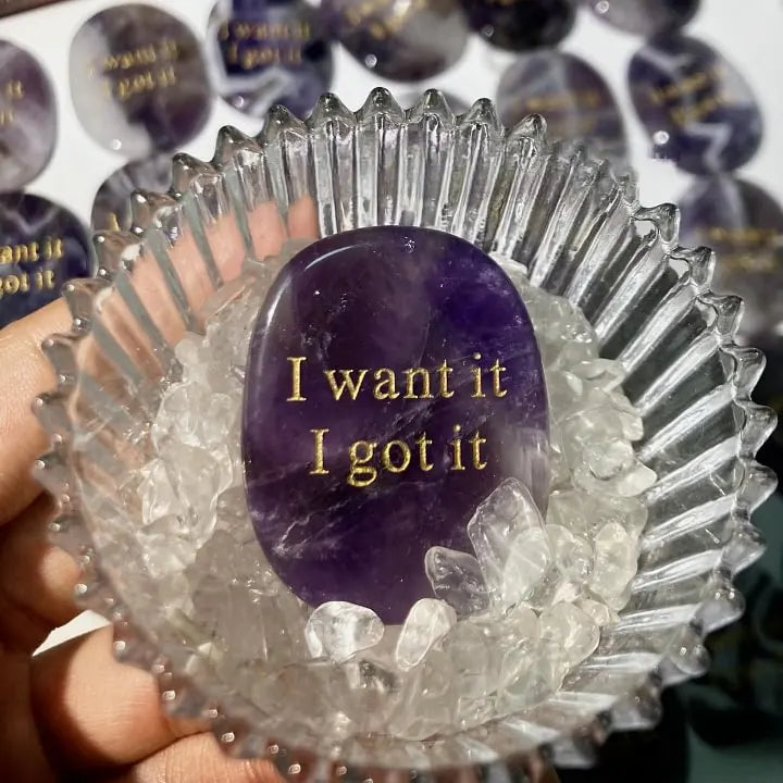 Amethyst affirmation stone with 'I want it I got it' in gold, nestled in clear quartz chips
