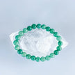 Green aventurine bracelet on clear quartz crystal for healing and chakra balance