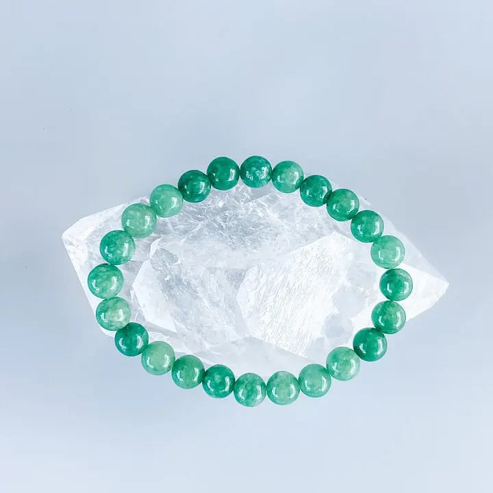 Green aventurine bracelet on clear quartz crystal for healing and chakra balance