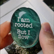 Green healing crystal with engraved affirmation 'I am rooted But I flow' for spiritual growth and mindfulness