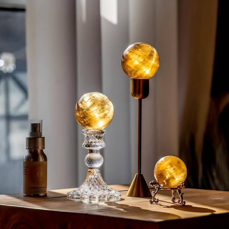 Glowing citrine crystal spheres on decorative stands for spiritual ambiance and chakra healing