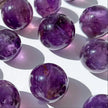 Polished amethyst crystal spheres for spiritual healing and chakra balance, ideal for anxiety relief and protection.