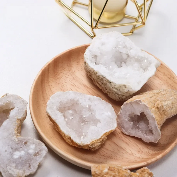 Raw crystal geodes on wooden plate, healing stones for spiritual growth and anxiety relief