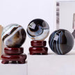 Polished agate crystal spheres on wooden stands for home decor and spiritual healing