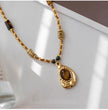 Handmade tiger eye gemstone necklace with gold beads and chakra stones for spiritual healing and protection