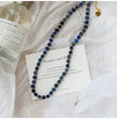 Lapis lazuli cube necklace with gold beads, romance quote card, and sandalwood spray for love and spiritual healing