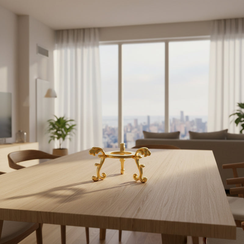 Golden ornate candle holder on wooden table in modern living room with city view