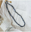 Handmade blue sodalite gemstone necklace with gold accents, ideal for love and spiritual healing.