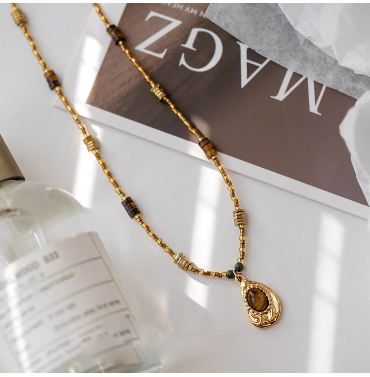 Gold beaded necklace with tiger eye pendant, healing crystal jewelry for spiritual growth and protection
