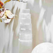 Clear selenite tower crystal for spiritual healing and energy cleansing, with autumn leaves and soft light