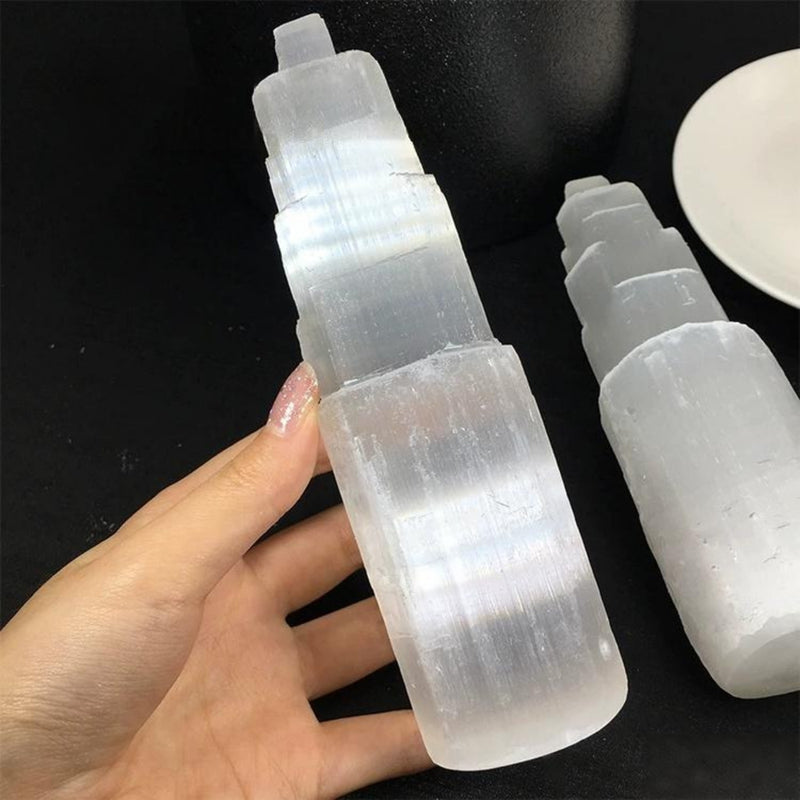 Hand holding a natural selenite spray bottle for crystal healing and spiritual cleansing