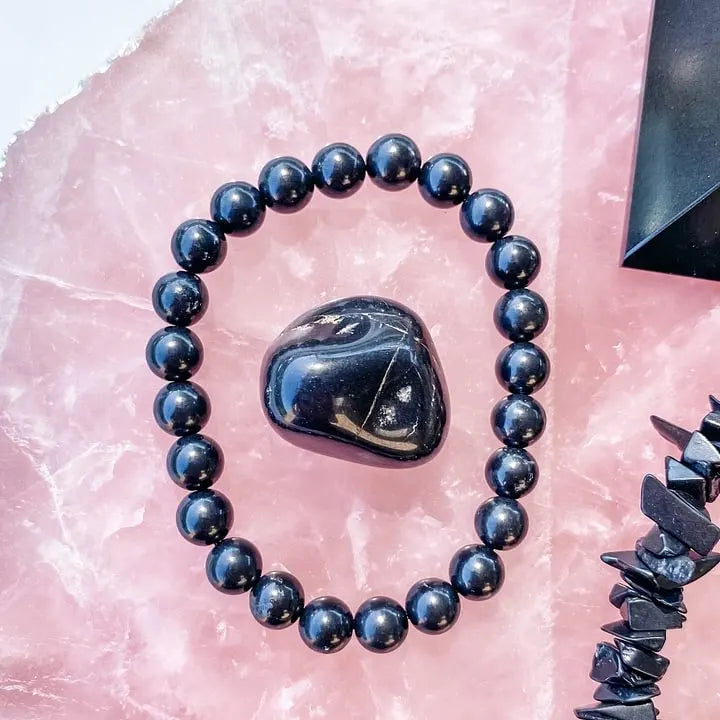 Black obsidian bracelet and tumbled stone on pink crystal, for protection and spiritual healing