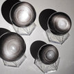 Shiny silver hematite spheres on crystal stands for spiritual healing and protection
