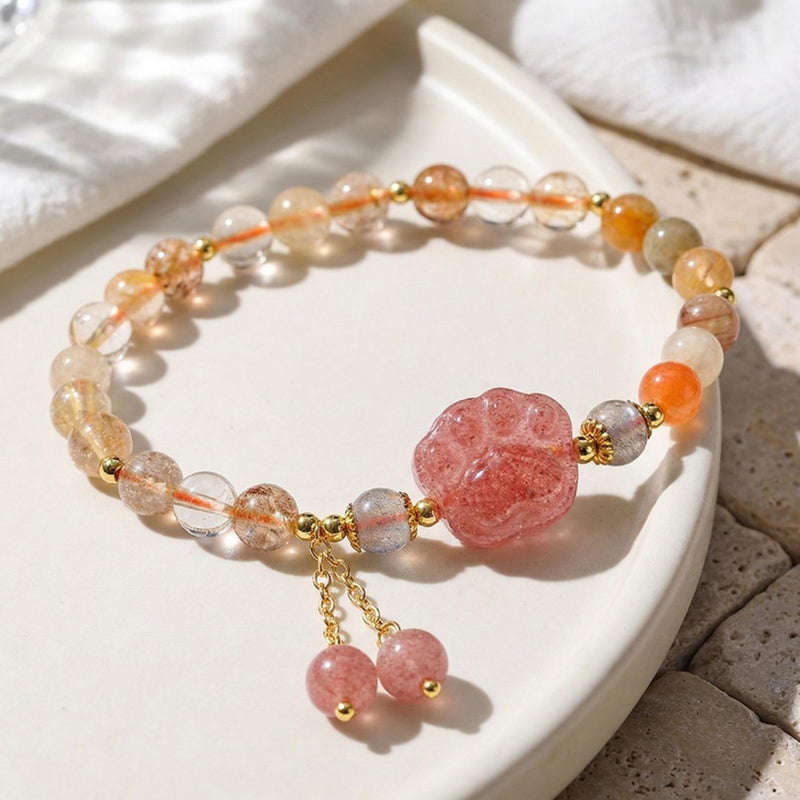 Handmade gemstone bracelet with pink carved charm, gold accents, and crystal beads for spiritual healing and love energy.