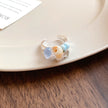 Handmade ring with seashell and blue gemstones, perfect for beach lovers and spiritual jewelry collections.