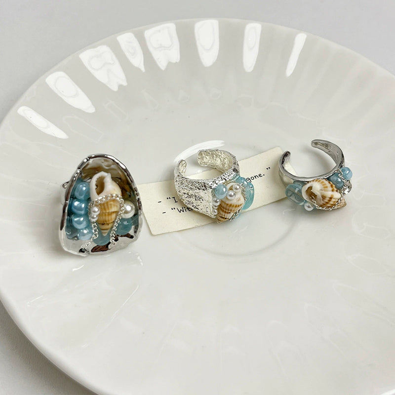 Handmade seashell and aquamarine gemstone rings for spiritual healing and coastal charm