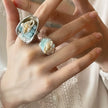 Handmade seashell and aquamarine gemstone rings, ocean-inspired jewelry with pearl accents for spiritual healing.