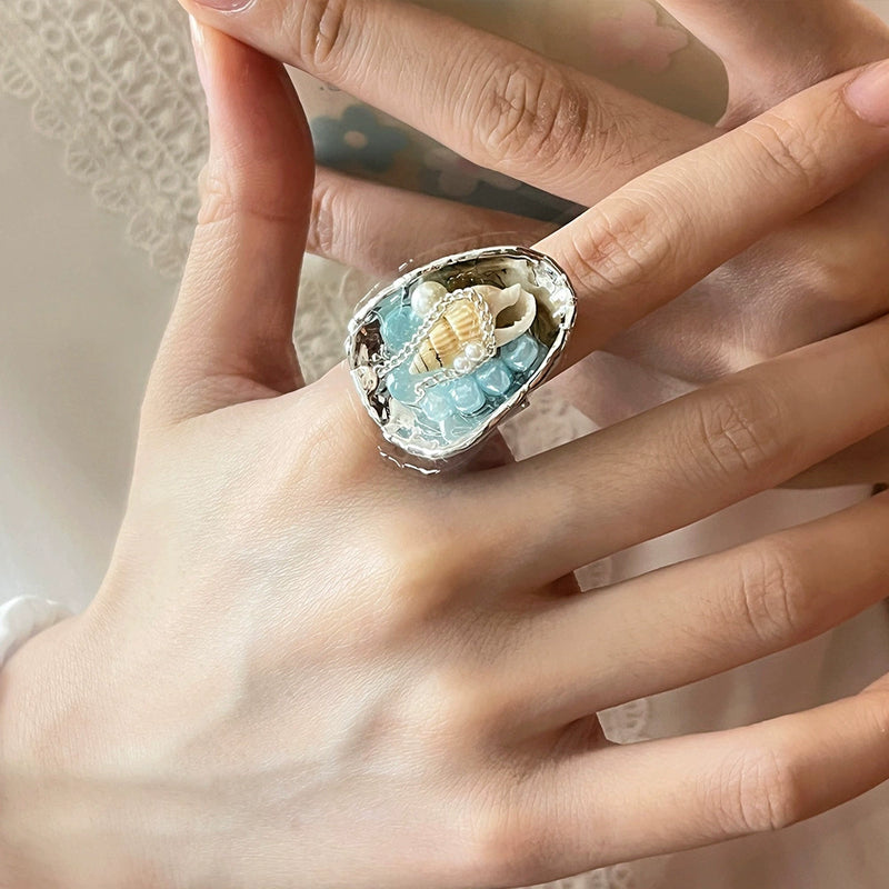 Handmade ring with seashell, pearls, and blue crystals for spiritual healing and protection