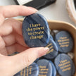 Hand holding blue sodalite affirmation stone engraved 'I have the power to create change' for spiritual growth and motivation