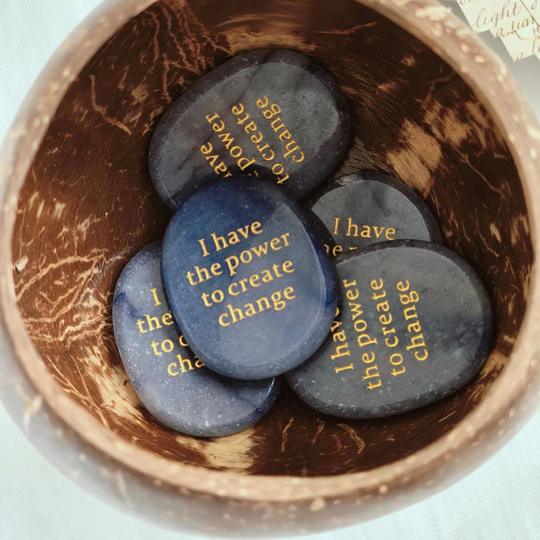 Affirmation stones with 'I have the power to create change' in coconut bowl, healing crystals for spiritual growth