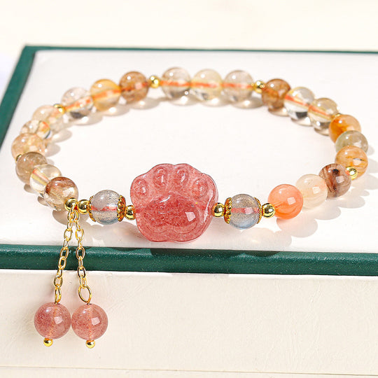 Strawberry quartz paw print bracelet with gold accents and dangling beads, ideal for healing and spiritual jewelry lovers.