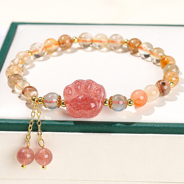Strawberry quartz paw print bracelet with gold accents and dangling beads, ideal for healing and spiritual jewelry lovers.