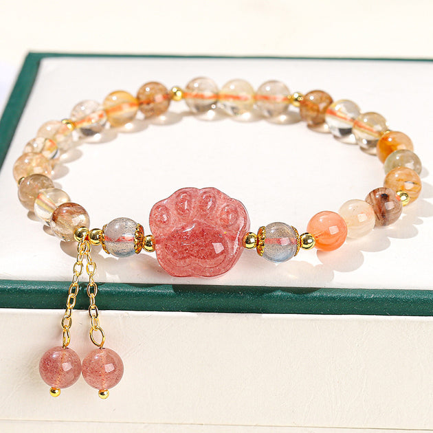 Strawberry quartz paw print bracelet with gold accents and dangling beads, ideal for healing and spiritual jewelry lovers.