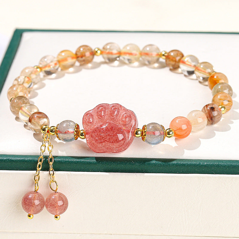 Strawberry quartz paw print bracelet with gold accents and dangling beads, ideal for healing and spiritual jewelry lovers.