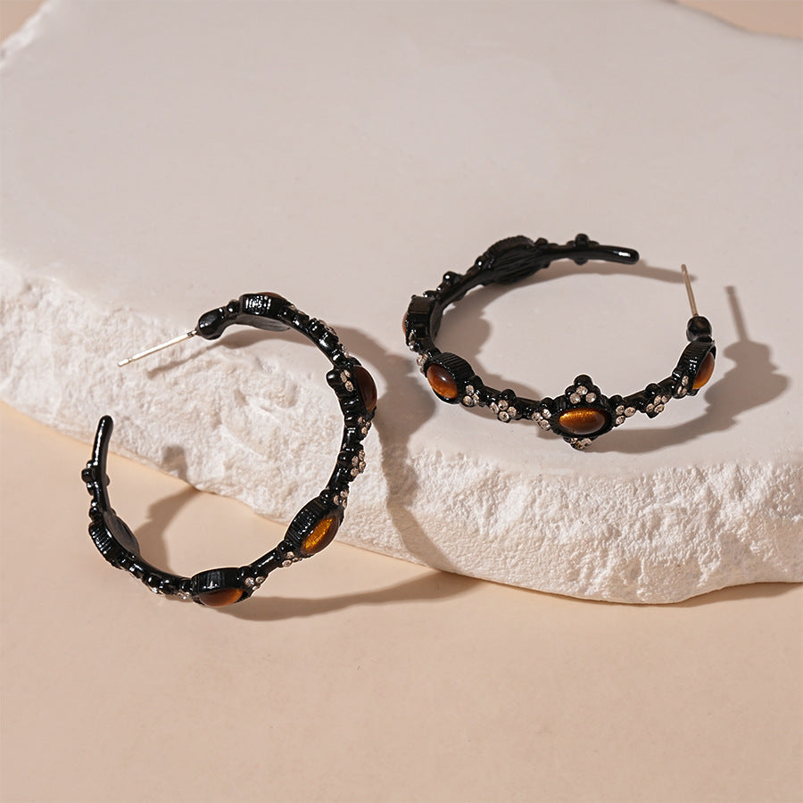 Black hoop earrings with tiger eye stones and crystal accents, handmade gemstone jewelry for spiritual healing.