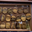 Tiger eye healing crystals engraved with 'Solvitur ambulando,' displayed with clear quartz points for spiritual growth.